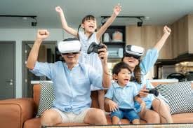Group of children and adults celebrating while wearing VR headsets.