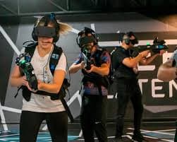 Team playing an immersive VR game experience together.